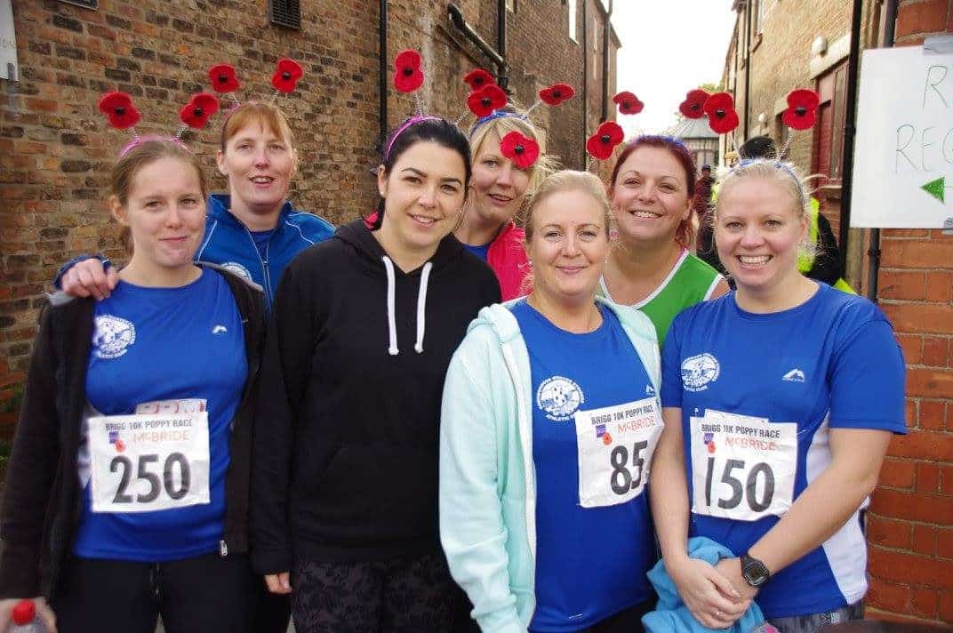 Runners with their running shirts and poppy headdress taking part in the Brigg 10k poppy race