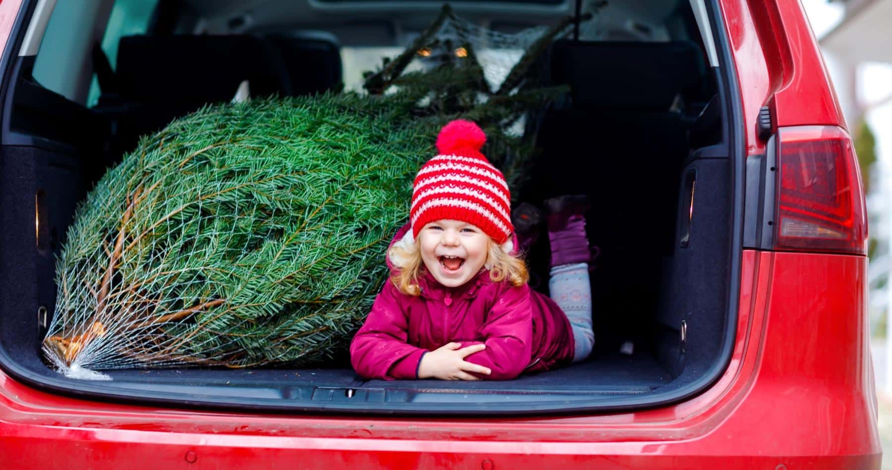 Little girl next to Christmas tree